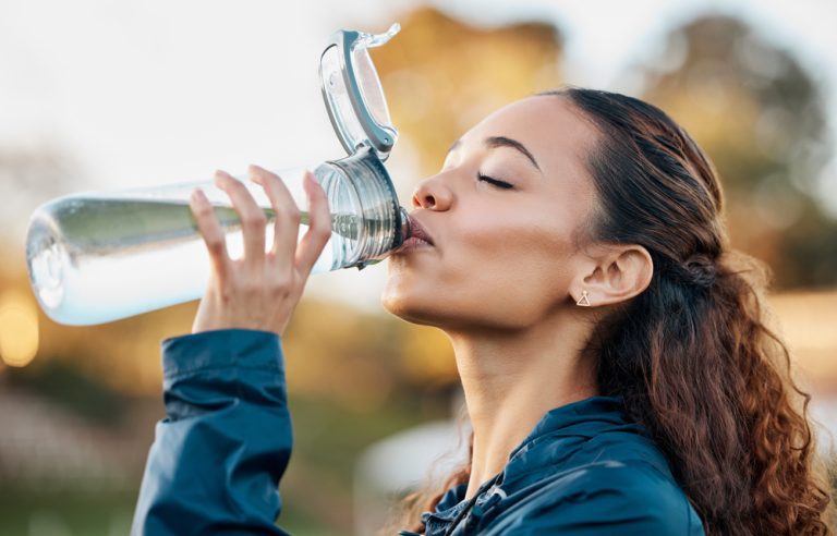 A woman drinking water for optimal hydration